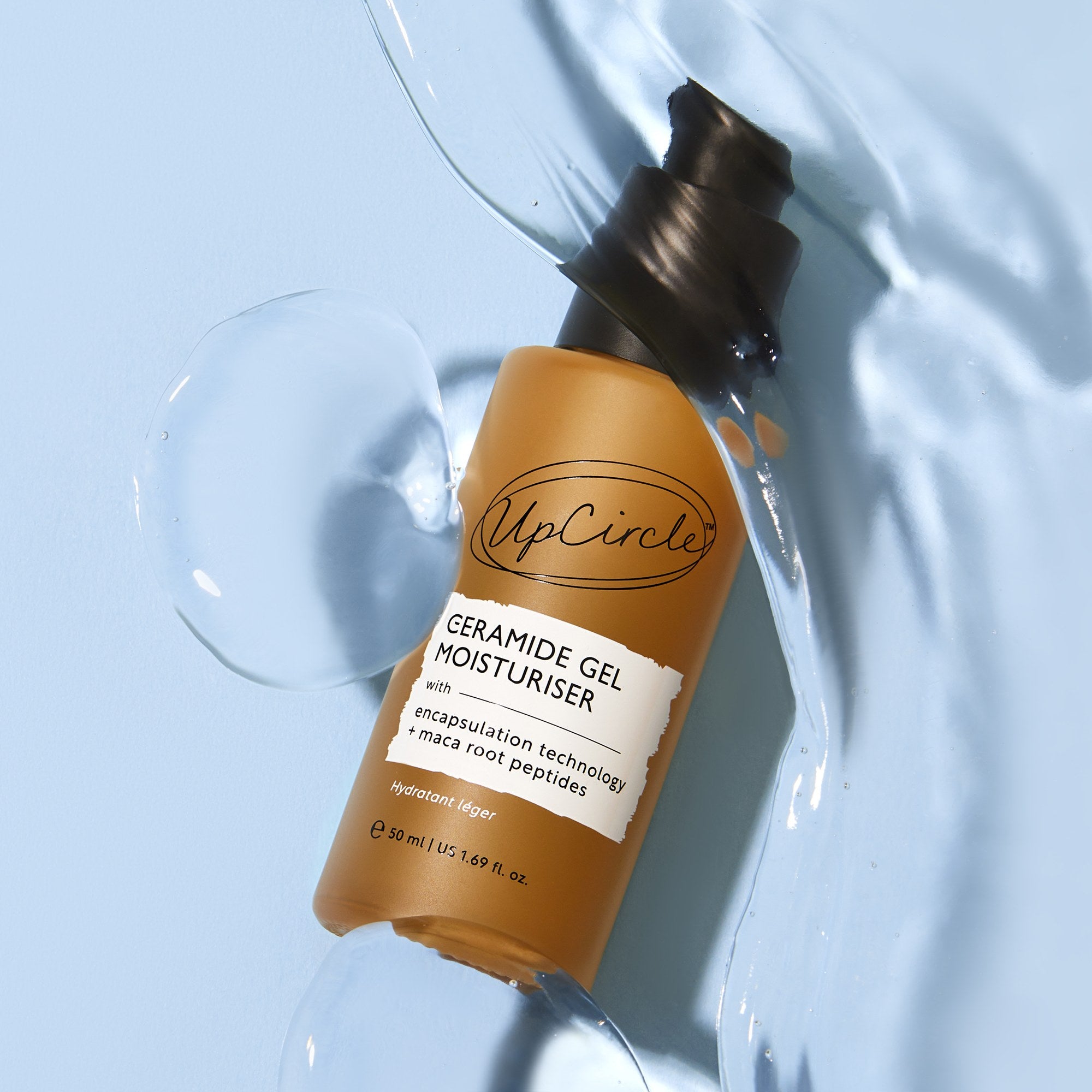 UpCircle Ceramide Gel Moisturizer bottle lying in a pool of the clear cooling gel